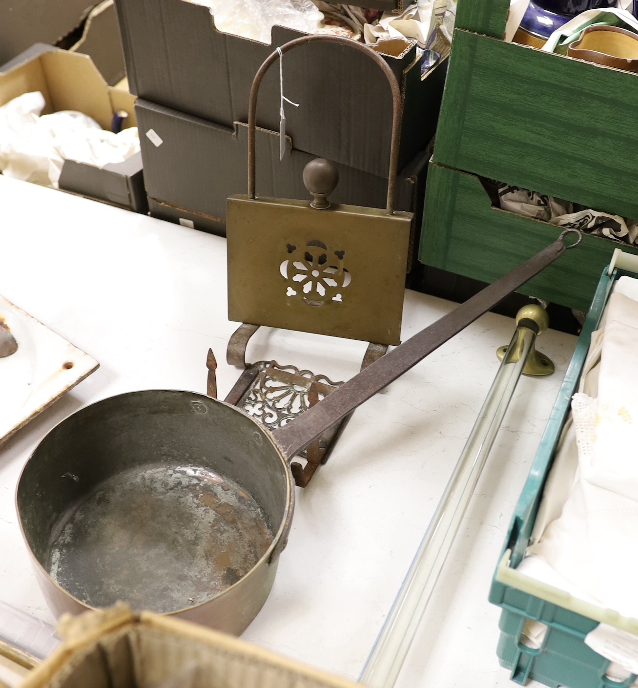 Two brass grate trivets, a crystal and brass towel rail and a 19th century copper pot